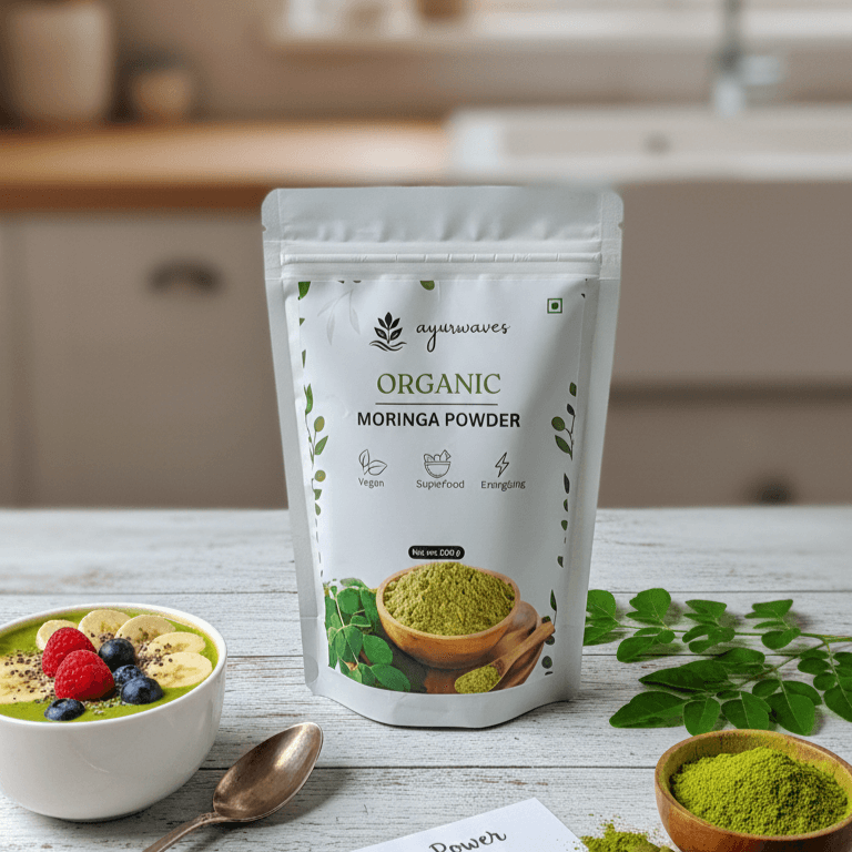 Ayurwaves Organic Moringa Powder package on a kitchen counter with a bowl of greens and leaves.